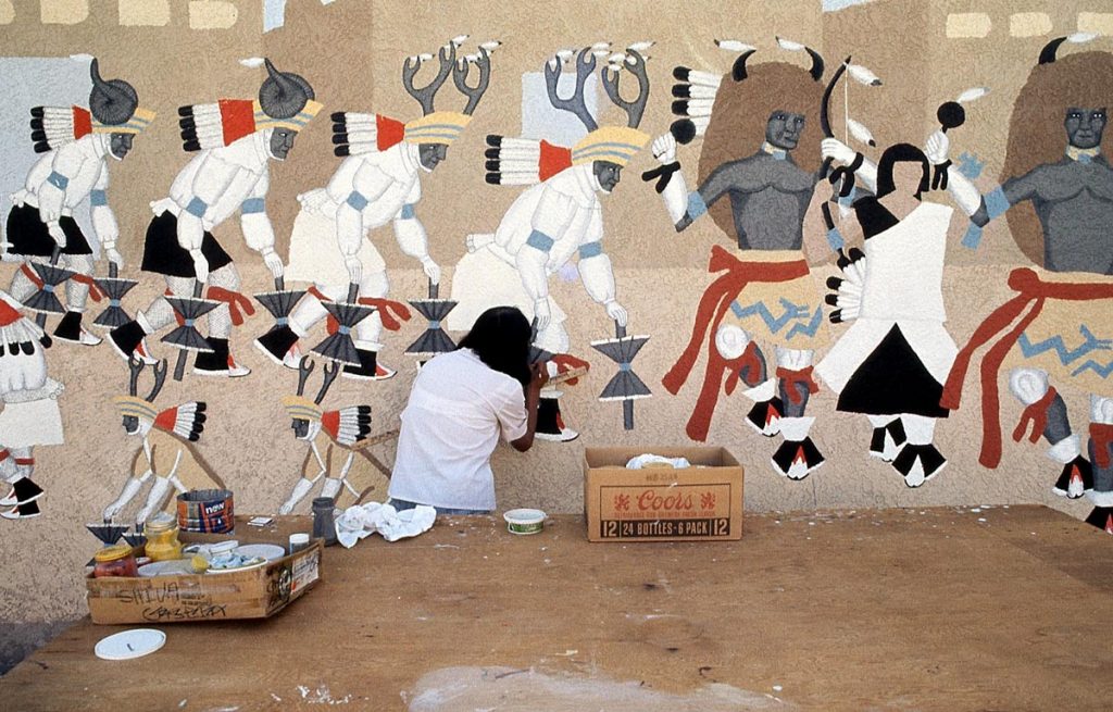 Pablita Velarde painting her mural at IPCC